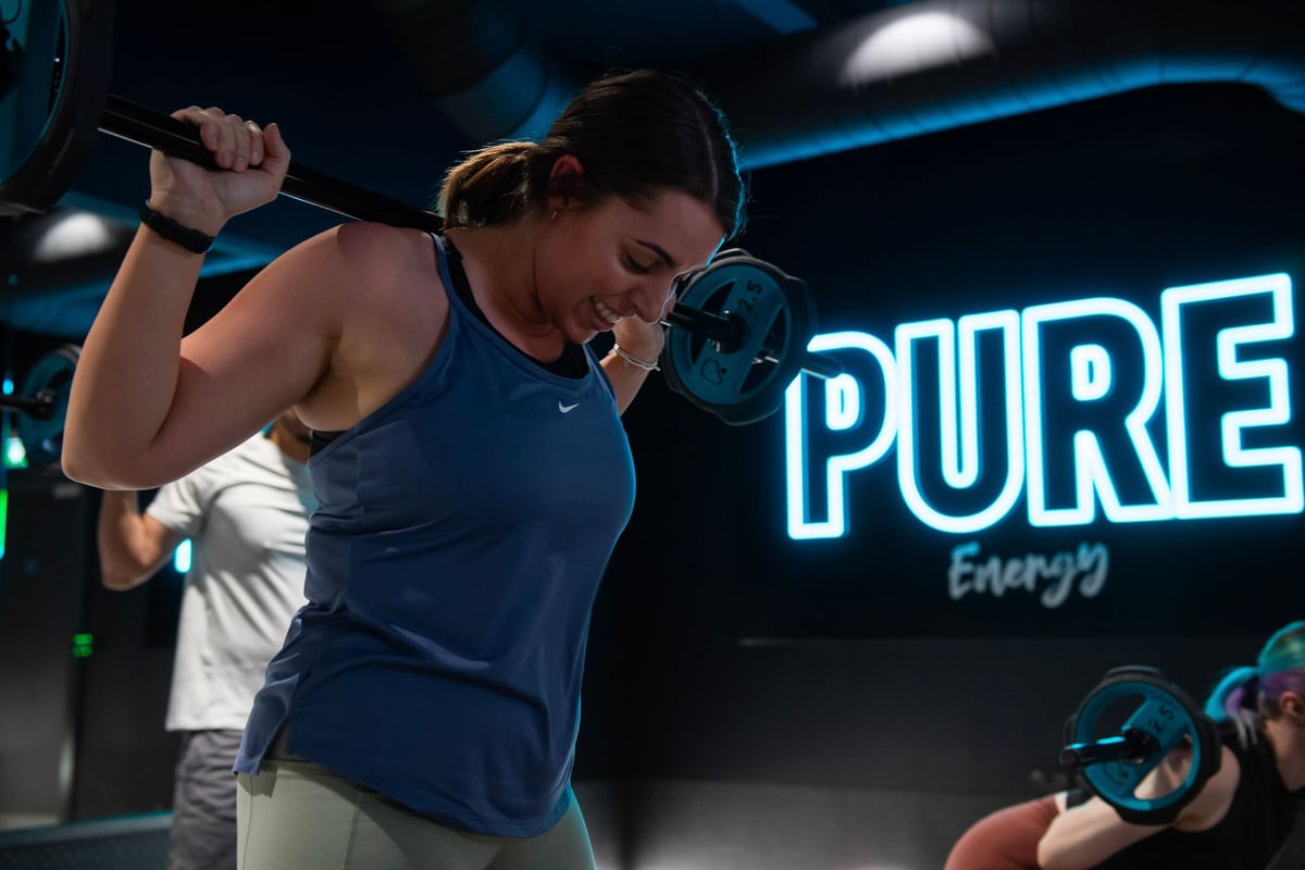 Girl lifting barbell with weights