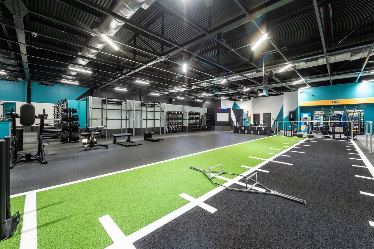 PureGym Southampton Bitterne: Functional training area with turf, weight racks, free weights, and rubberized flooring.