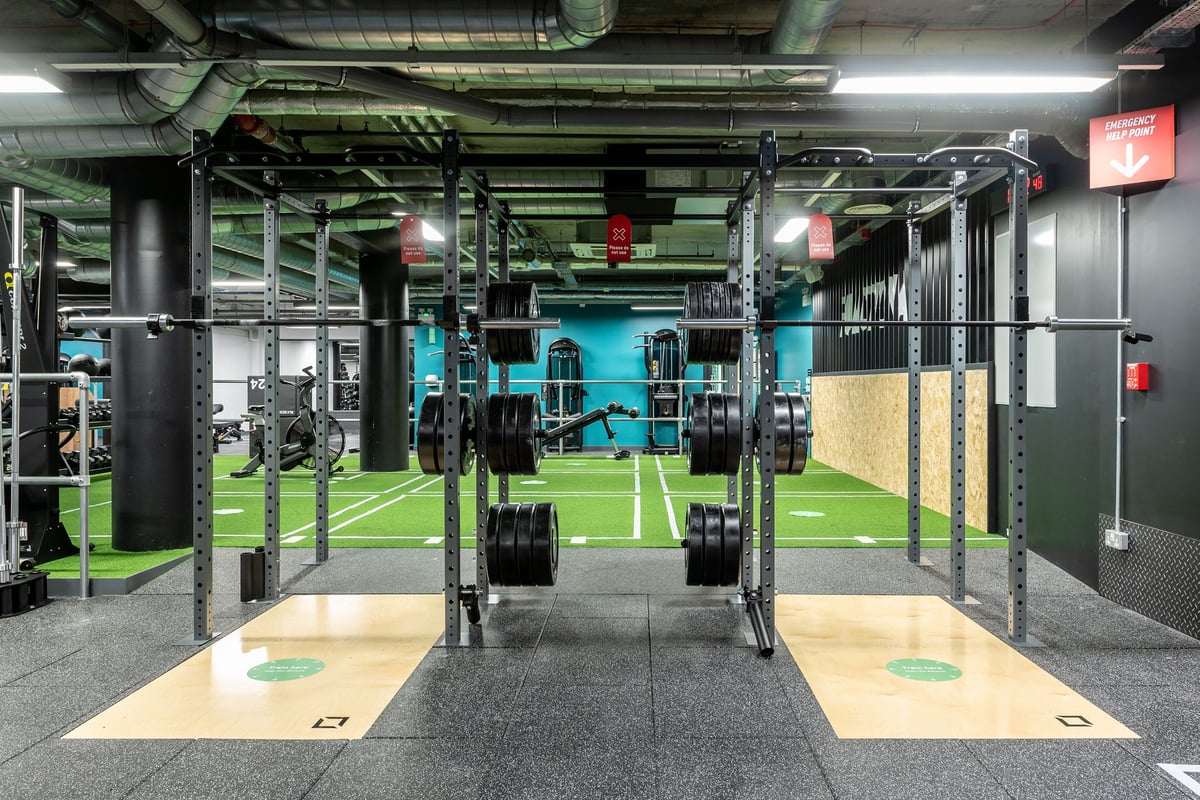 PureGym London Camberwell New Road: Strength training rig, punch bags, weight racks, turf area, and mirrored wall.