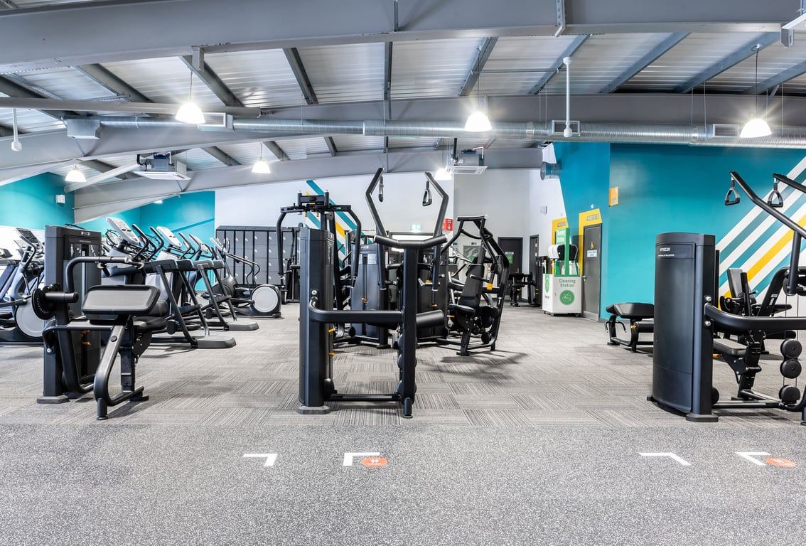 PureGym Bournemouth Mallard Road Retail Park: Gym floor with resistance machines and colourful accent walls.