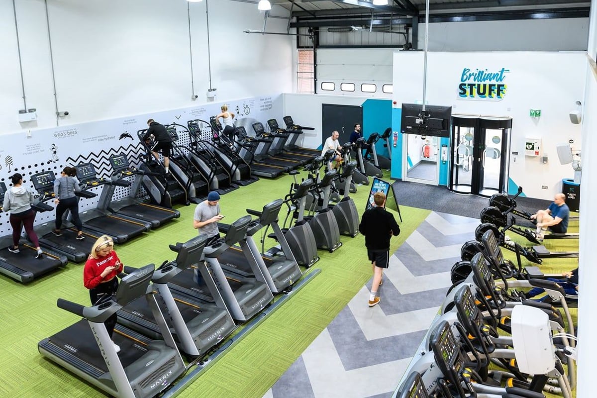 PureGym Reading Caversham Road: Rows of treadmills, stationary bikes, and other cardio machines on rubberised flooring.