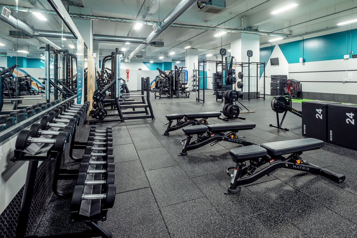 PureGym Leicester St Georges Way: Rows of weight racks, benches, dumbbells, and resistance machines in a modern gym interior.