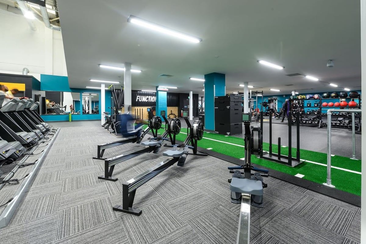 PureGym London Hayes: Treadmills, weight machines, free weights, benches, and resistance tubing in a colourful fitness studio.