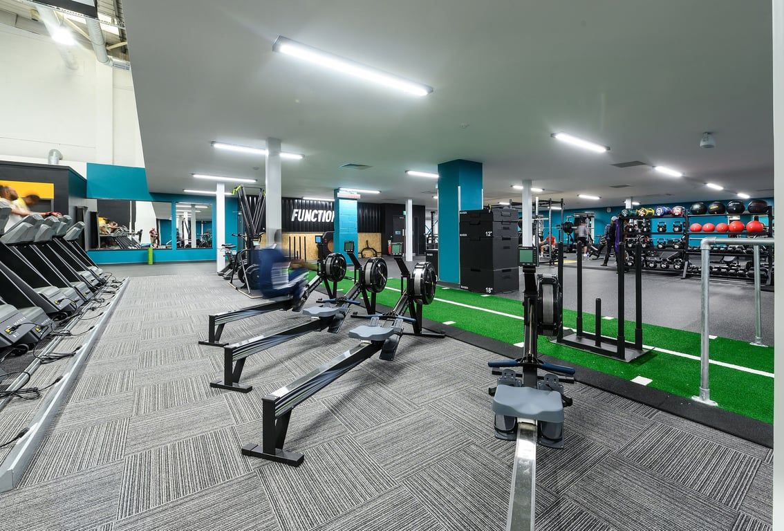 PureGym London Hayes: Treadmills, weight machines, free weights, benches, and resistance tubing in a colourful fitness studio.