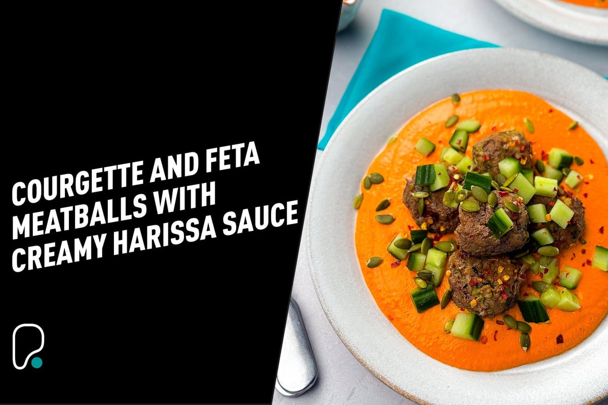 Meatballs on creamy orange harissa sauce garnished with diced cucumber and seeds