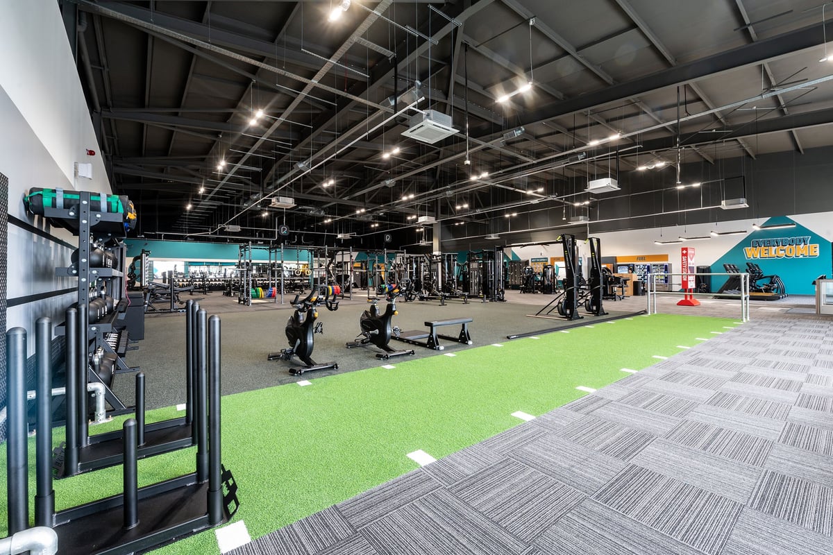 PureGym Walsall Crown Wharf: Functional training area with green turf, weight racks, free weights, and exercise machines.