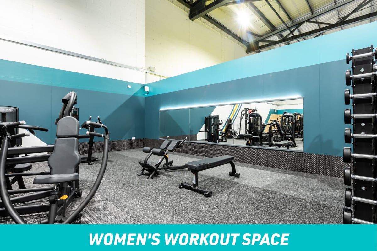 PureGym York Women's Workout Space: large mirror, exercise benches and chest press machine