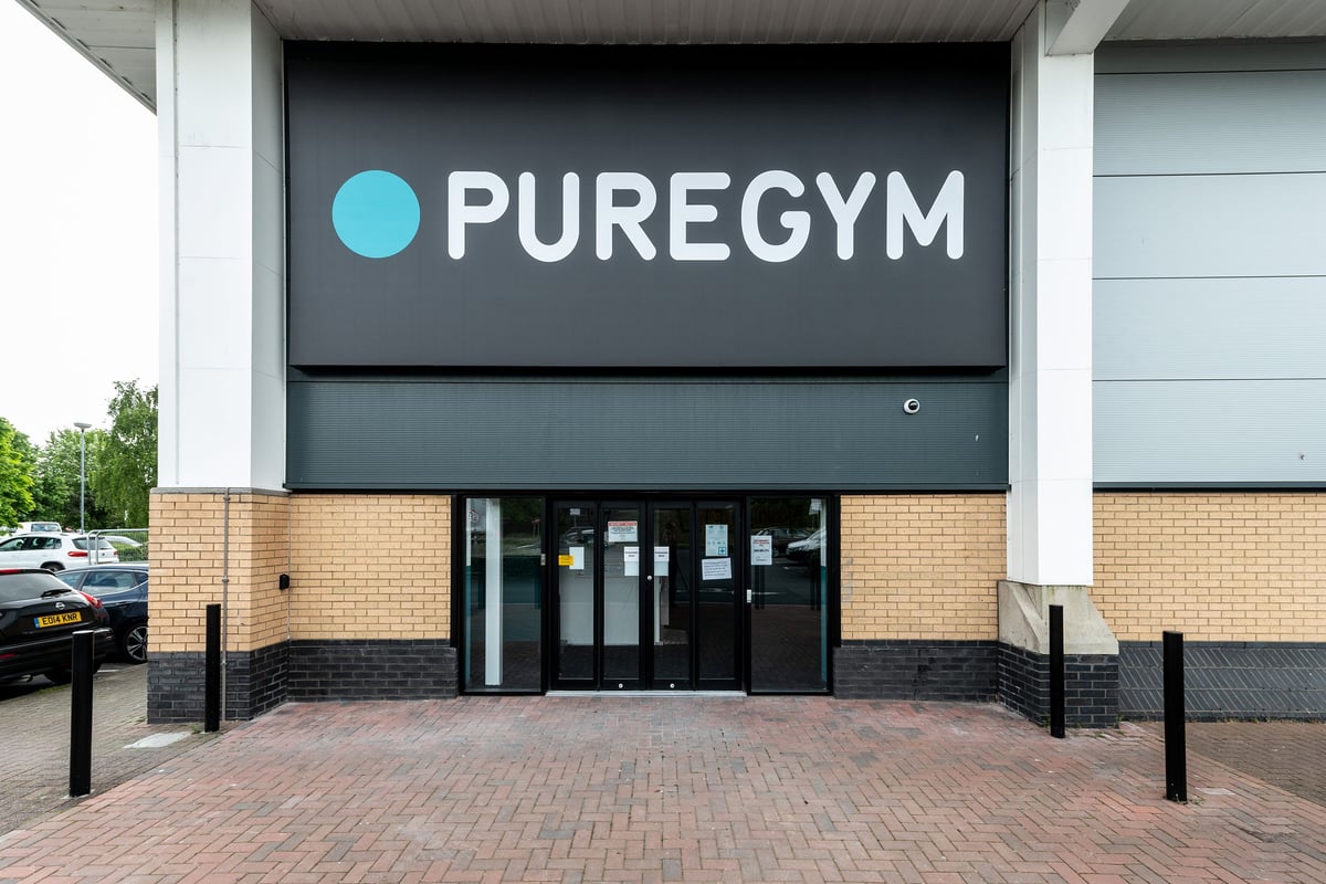 PureGym Cardiff Western Avenue: Gym exterior signage and entrance with brick paving and parking area.