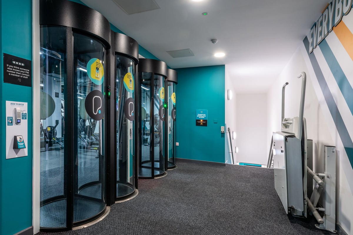 PureGym Manchester Market Street: Gym foyer with glass entry pods.
