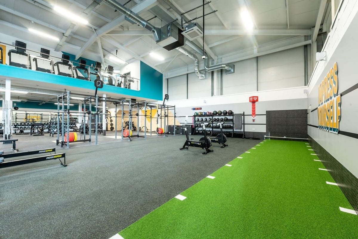 PureGym Trowbridge: Weight racks, resistance machines, free weights, turf area, mirrors, and rubberised flooring.