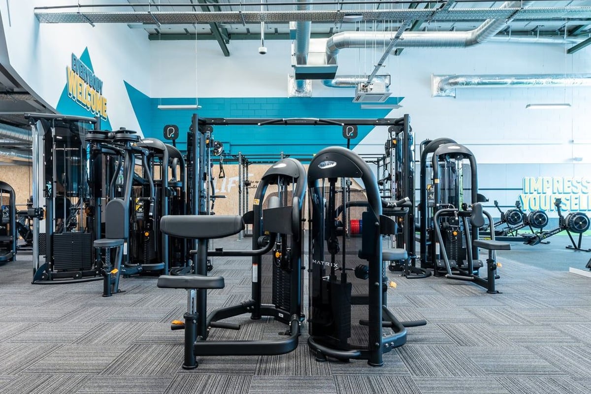 PureGym Coleraine: Resistance machines, weight stacks, benches, and rubberized flooring in a gym studio.