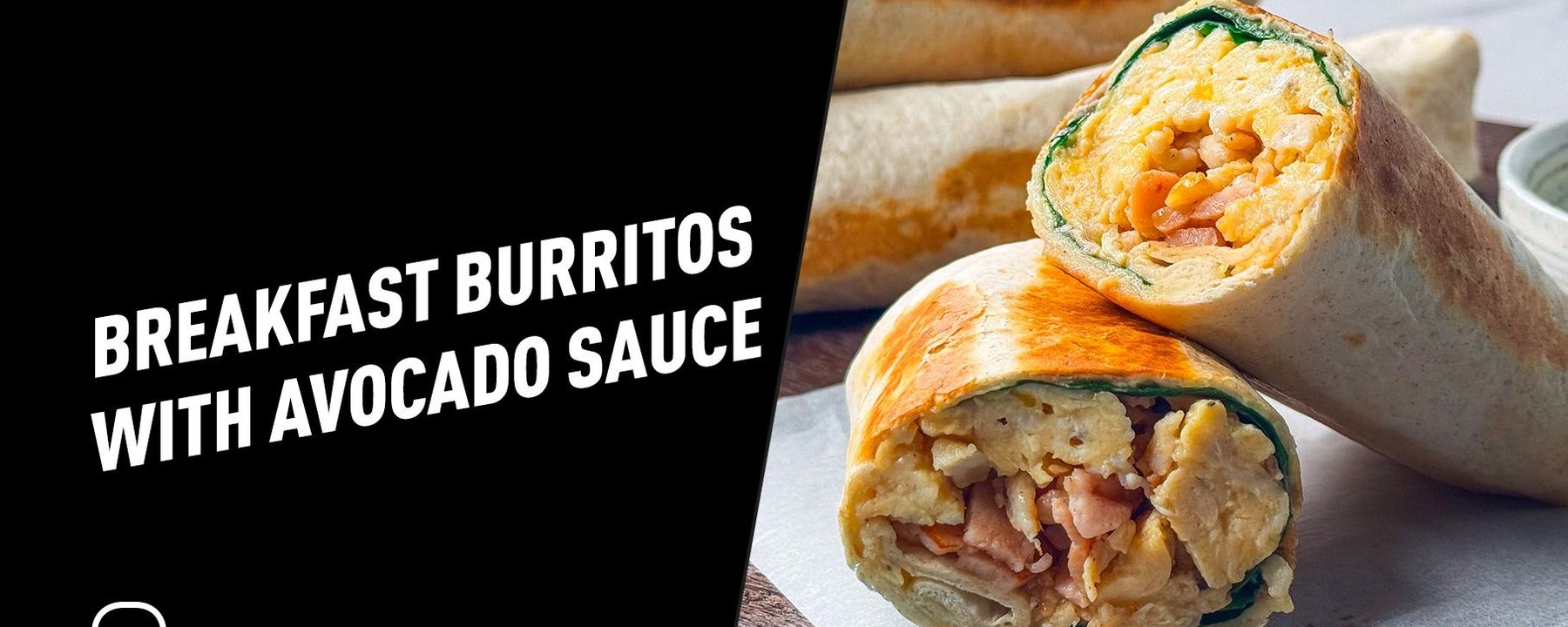 Two breakfast burritos cut in half showing scrambled eggs and bacon inside on a wooden board
