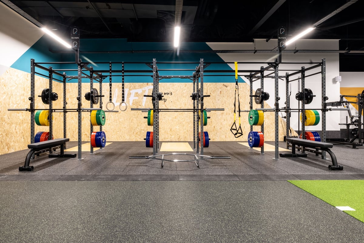 PureGym Hartlepool: Rig of squat racks, weight plates, suspension trainers, on rubberized floor.