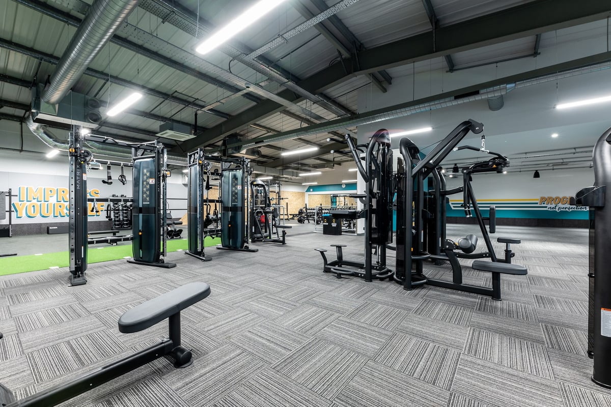 PureGym Alloa: Weight machines, benches, barbells, resistance equipment in an industrial-style gym setting.