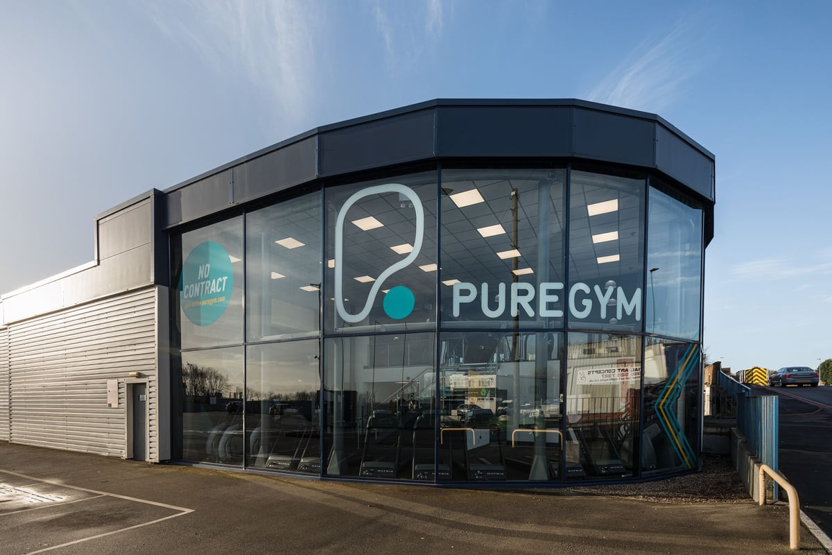 PureGym Dudley Tipton: Modern gym exterior with large glass windows bearing its logo and name.