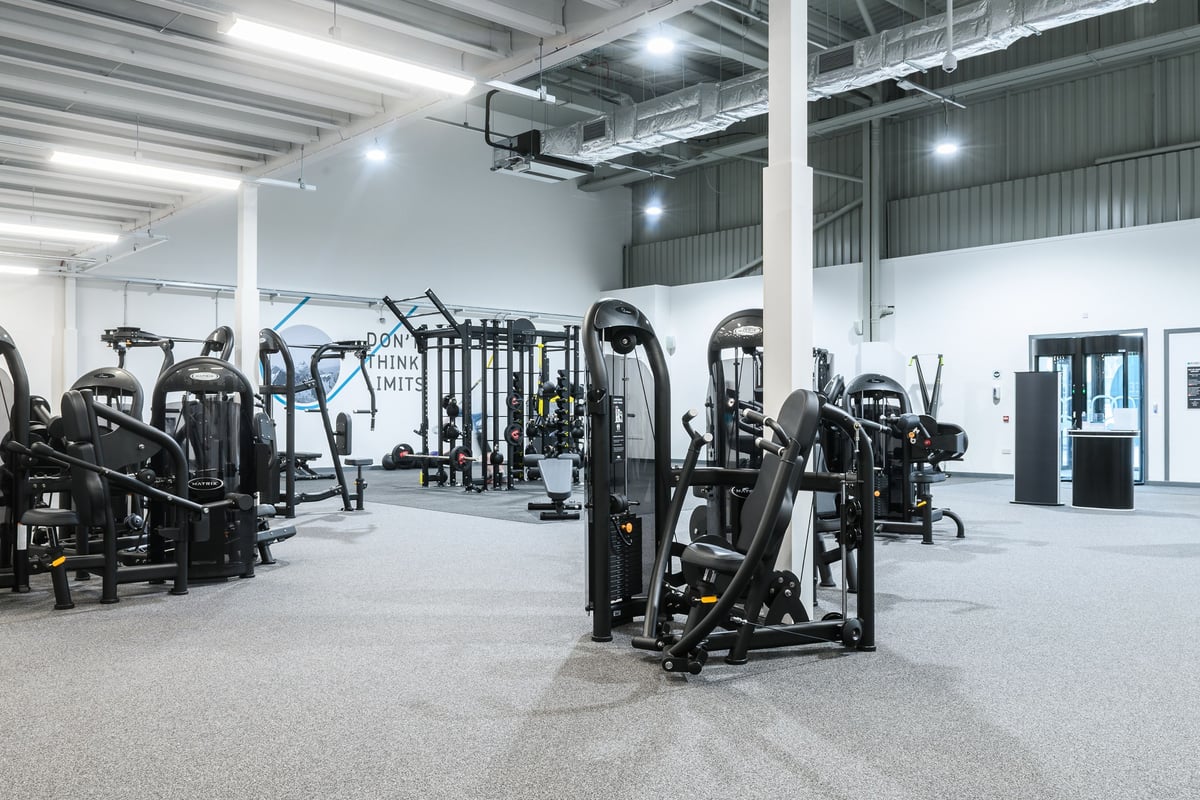 PureGym Aberdeen Wellington Circle: Rows of weight machines, cable stations, and heavy-duty benches with rubberized flooring.