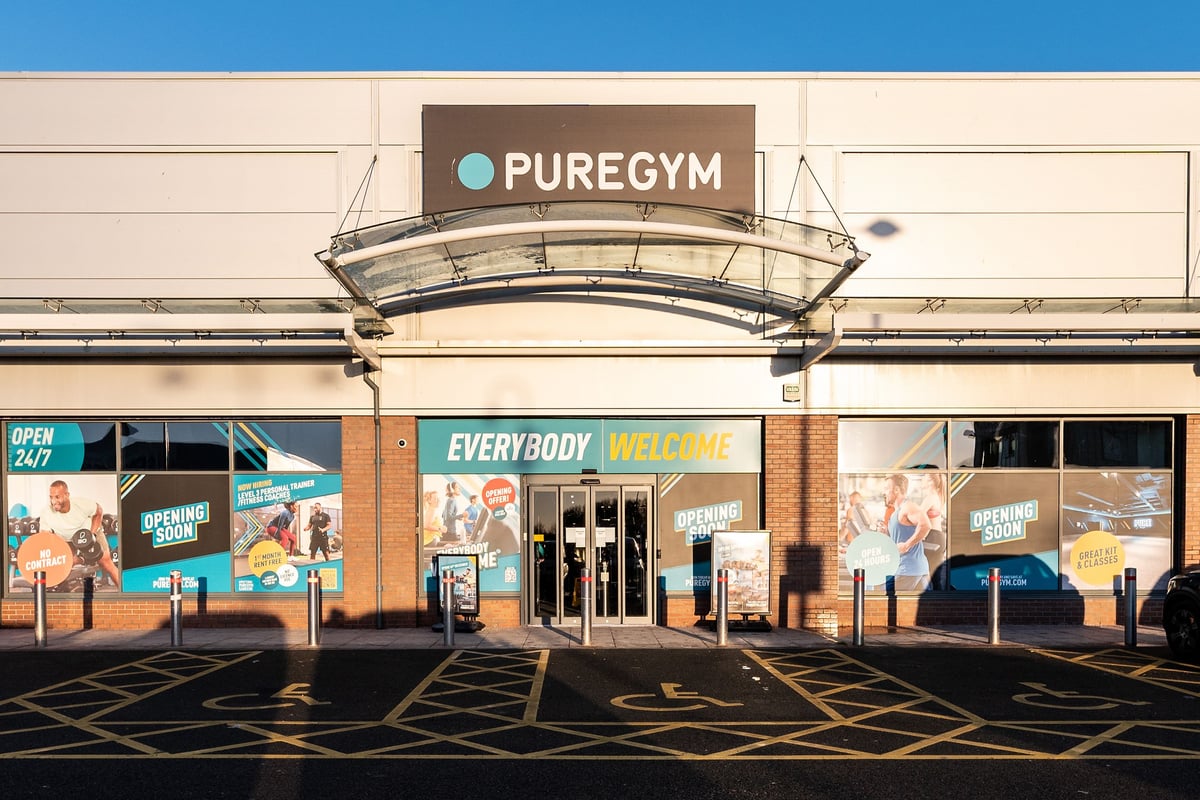 PureGym Consett: The exterior of a gym facility named PureGym with signage and parking spaces.