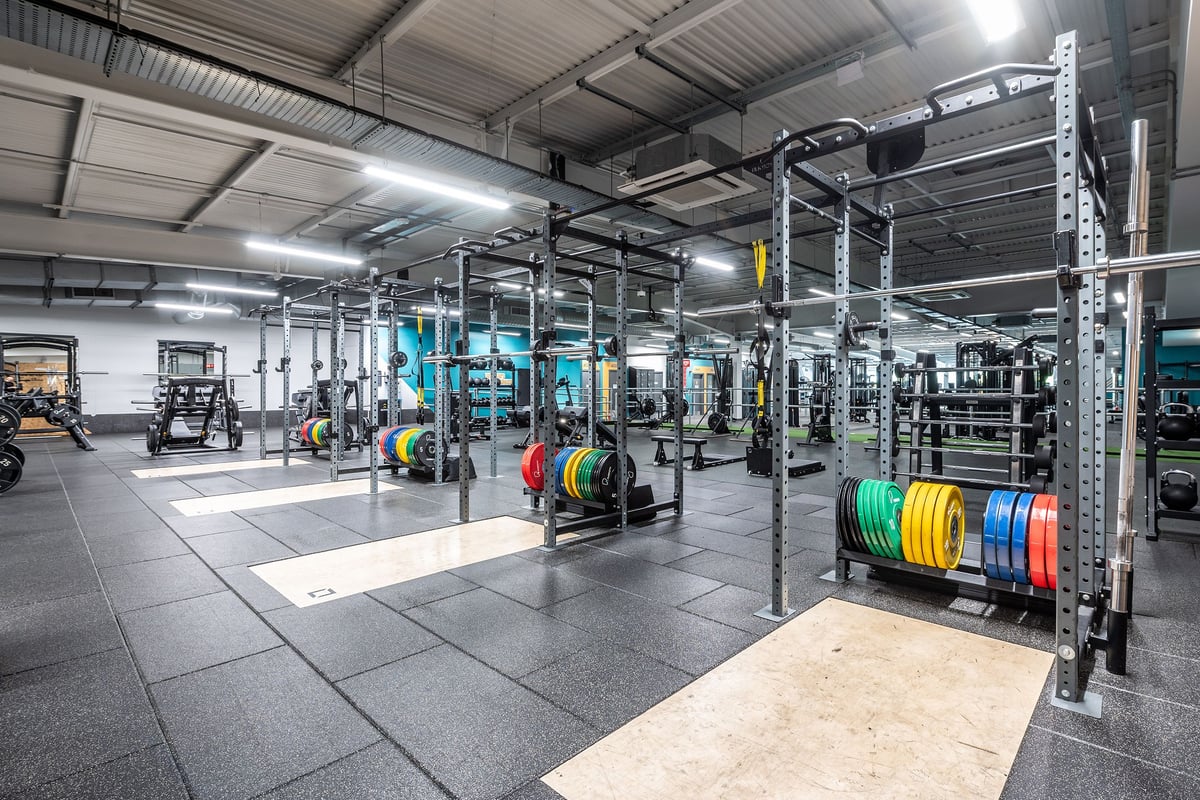 PureGym Manchester Cheetham Hill Retail Park: Weight racks, barbells, plates in vibrant colours, and rubber gym floors.