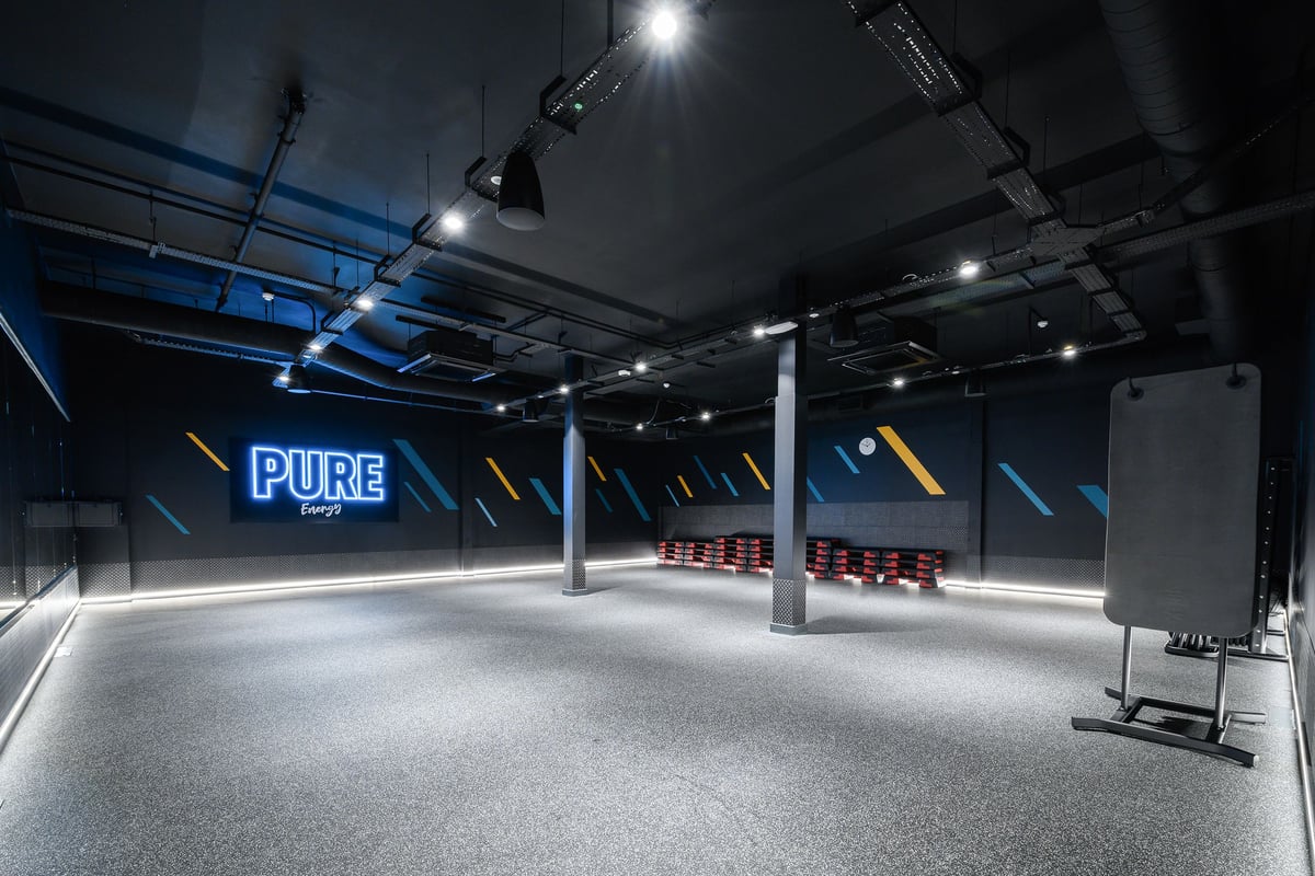 PureGym South Ruislip: Empty studio space with benches, studio lights, and Pure branding signage.