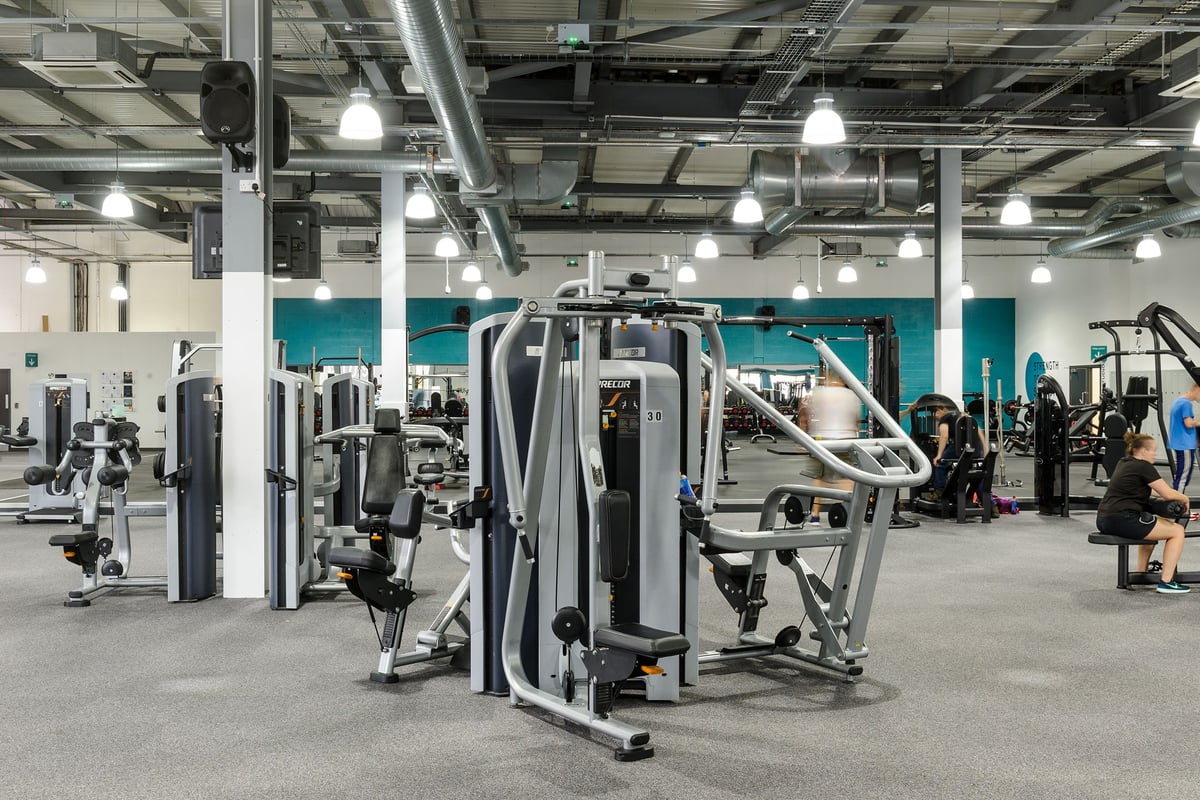 PureGym Worcester: Cable crossover machines, resistance equipment, weight stacks, and padded benches in a gym setting.
