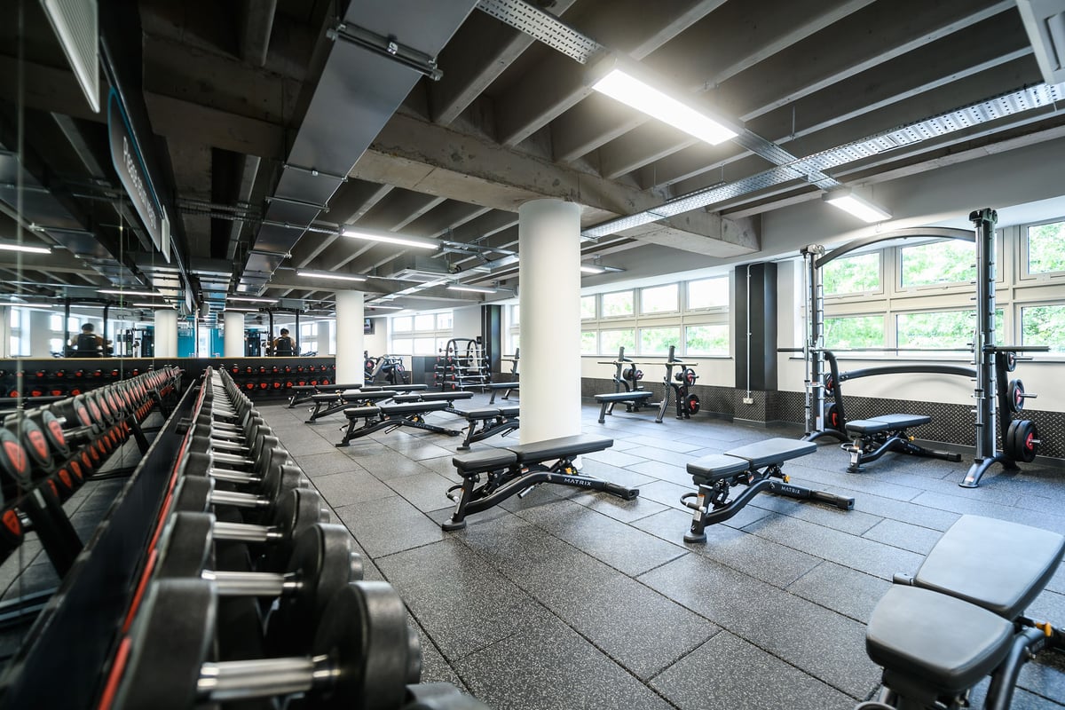 PureGym Birmingham Arcadian Centre: Weight racks, benches, dumbbells, rubberised flooring in a spacious gym facility.