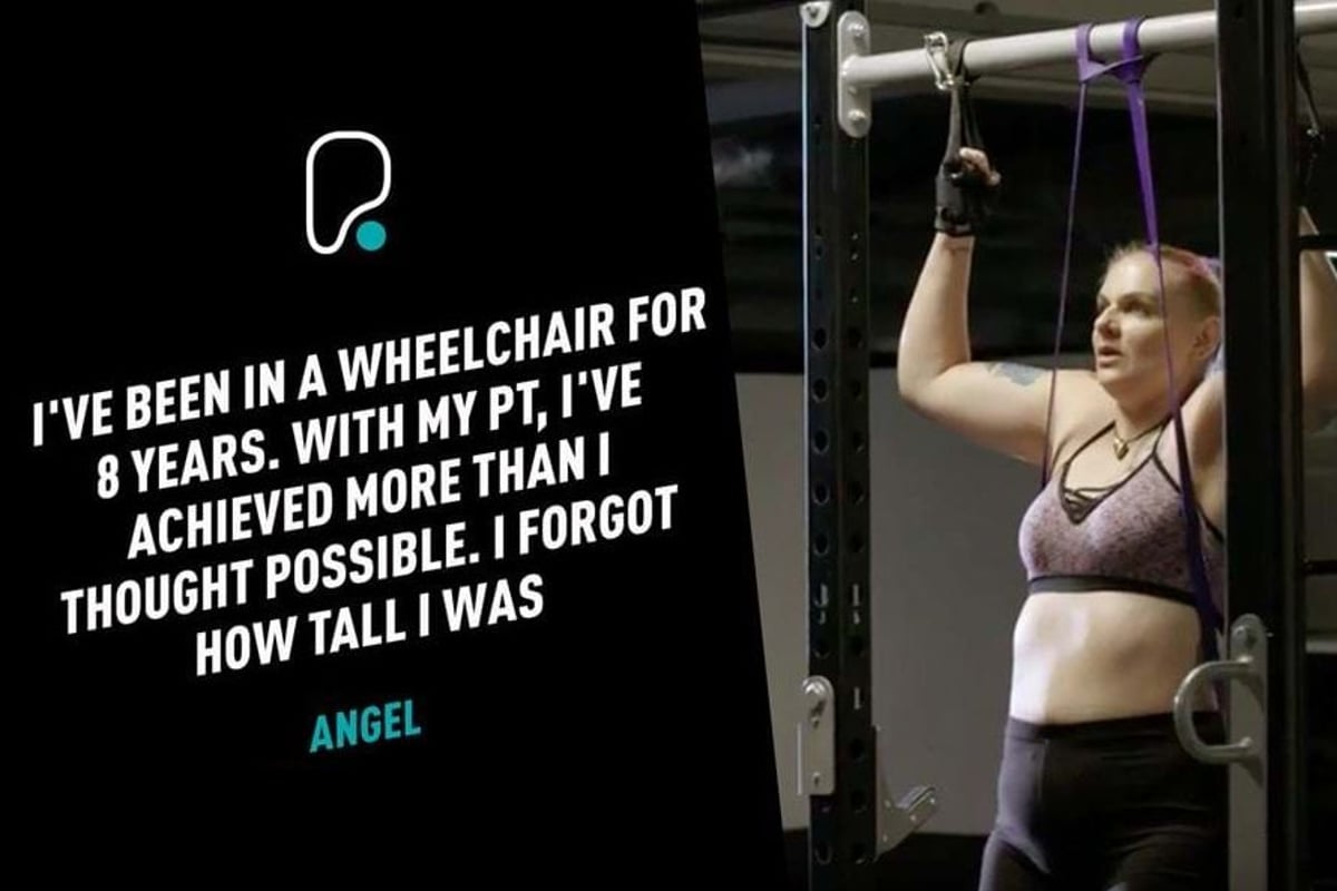 Woman in sportswear using resistance bands on gym equipment for pull-ups.