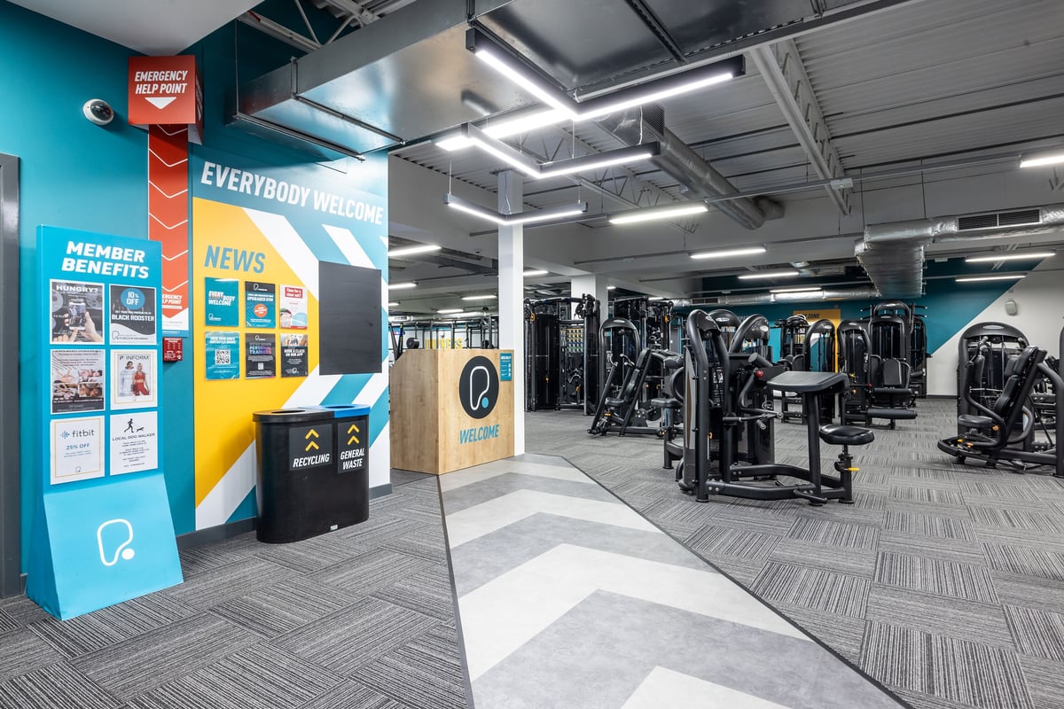PureGym Motherwell: Weight machines, resistance equipment, and mirrored walls in a modern gym interior.