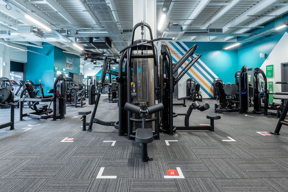 PureGym Aldershot Westgate Retail Park: Weight machines, resistance equipment, and teal accent walls in a gym studio.