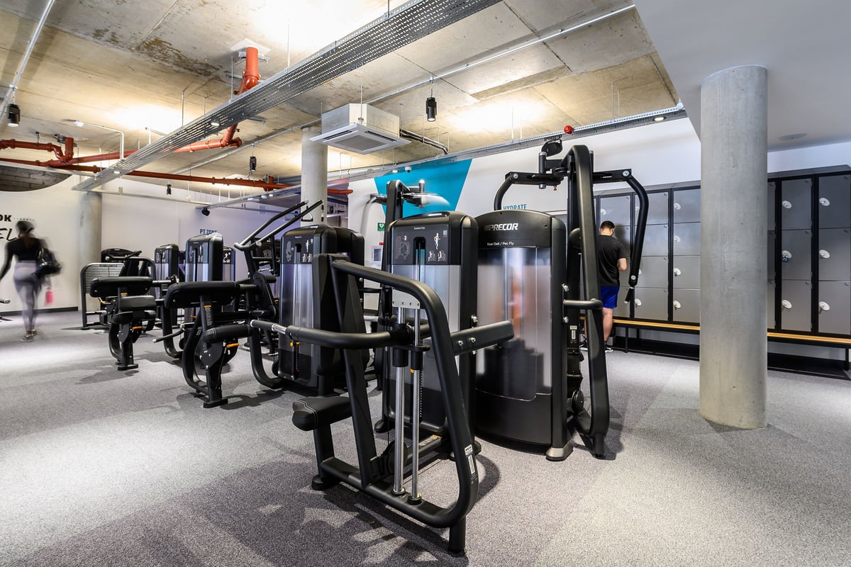 PureGym London Fulham: Strength training equipment, weight machines, and rubberized flooring in a basement gym area.
