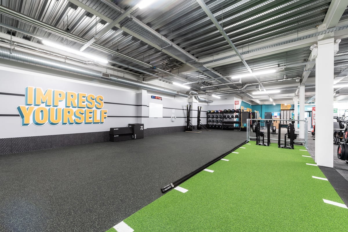 PureGym Banbury Cross Retail Park: Rubberized flooring, green turf area, free weights, equipment for functional training.