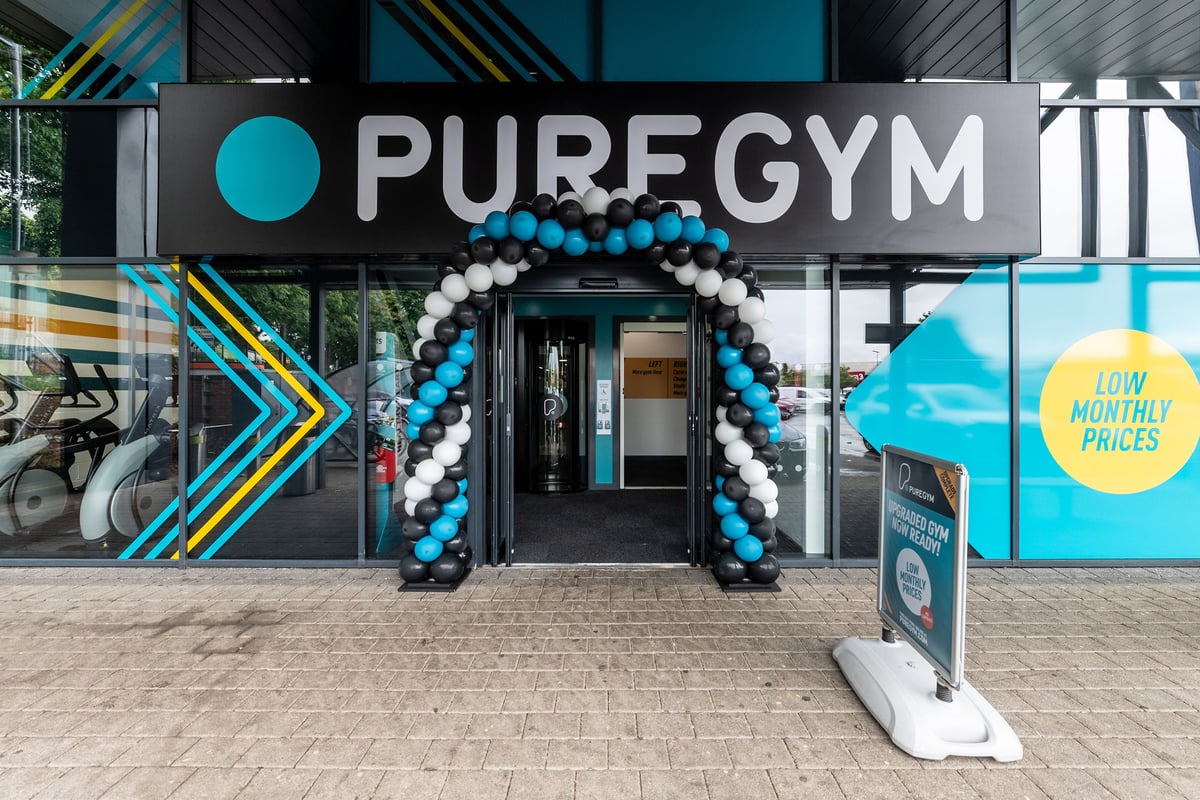 PureGym Banbury Cross Retail Park: Gym entrance with teal balloons archway and promotional signage.