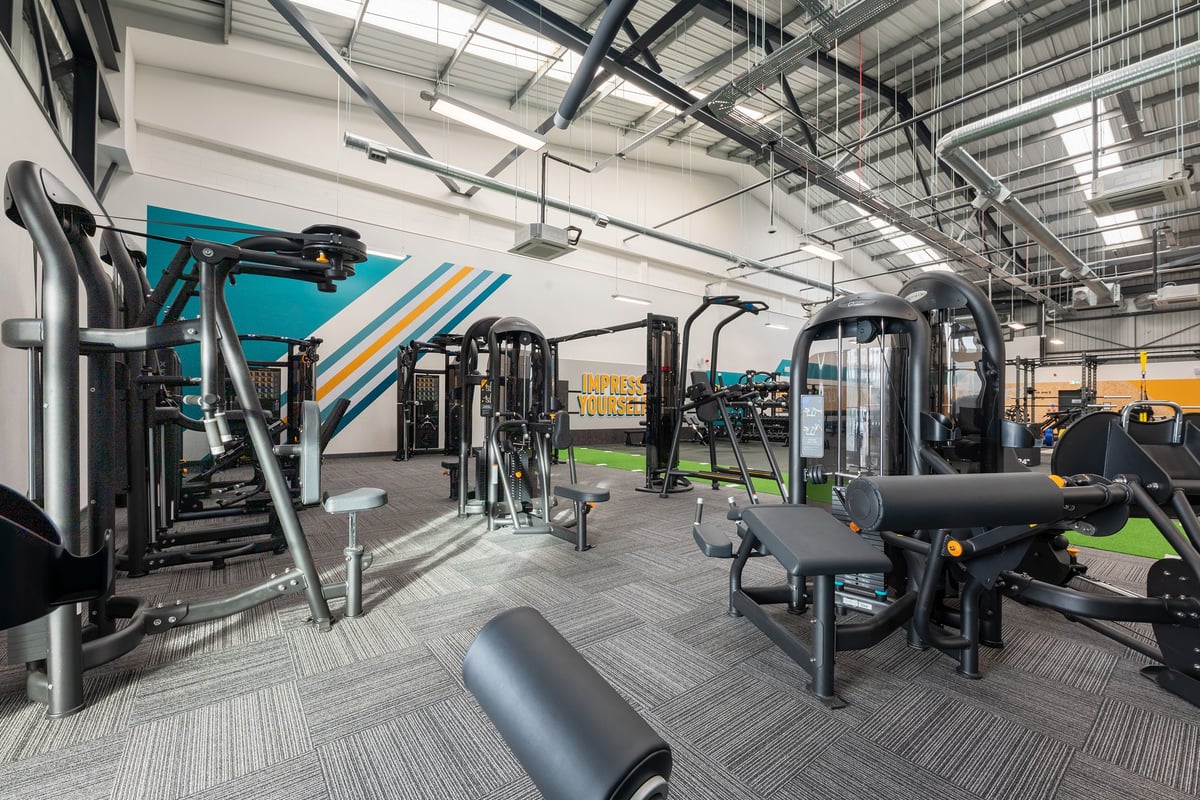 PureGym Southport: Industrial-style gym with resistance machines, cable crossovers, free weights, and padded flooring.