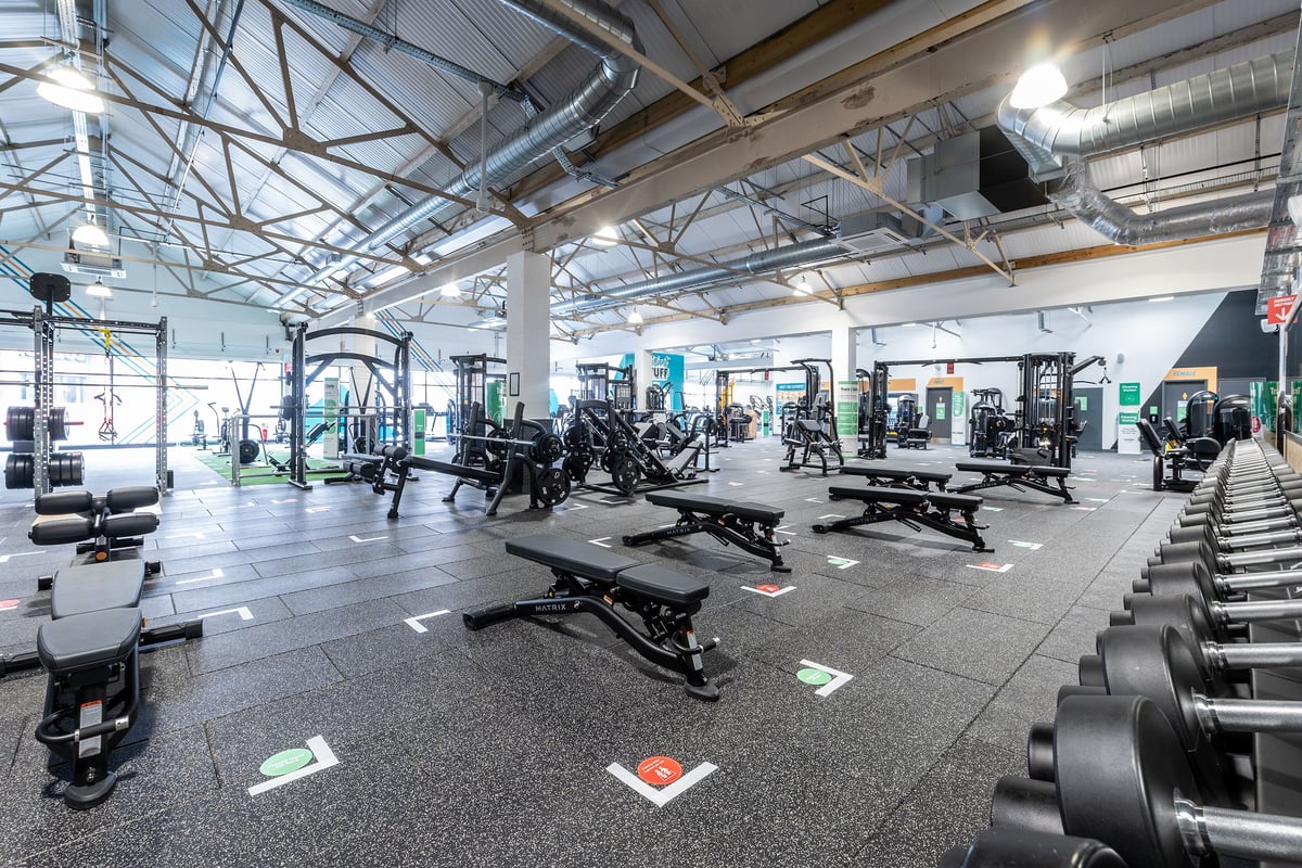 PureGym Puregym Crayford: Weight machines, benches, dumbbells, barbells, and rubberized flooring in a spacious gym interior.