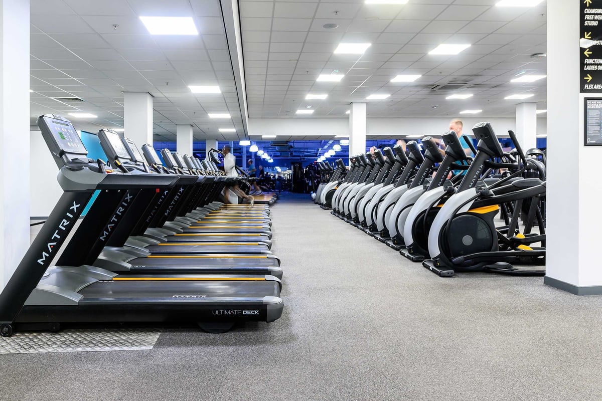 PureGym Glasgow Shawlads: Rows of treadmills and other aerobic machines in a modern gym facility.
