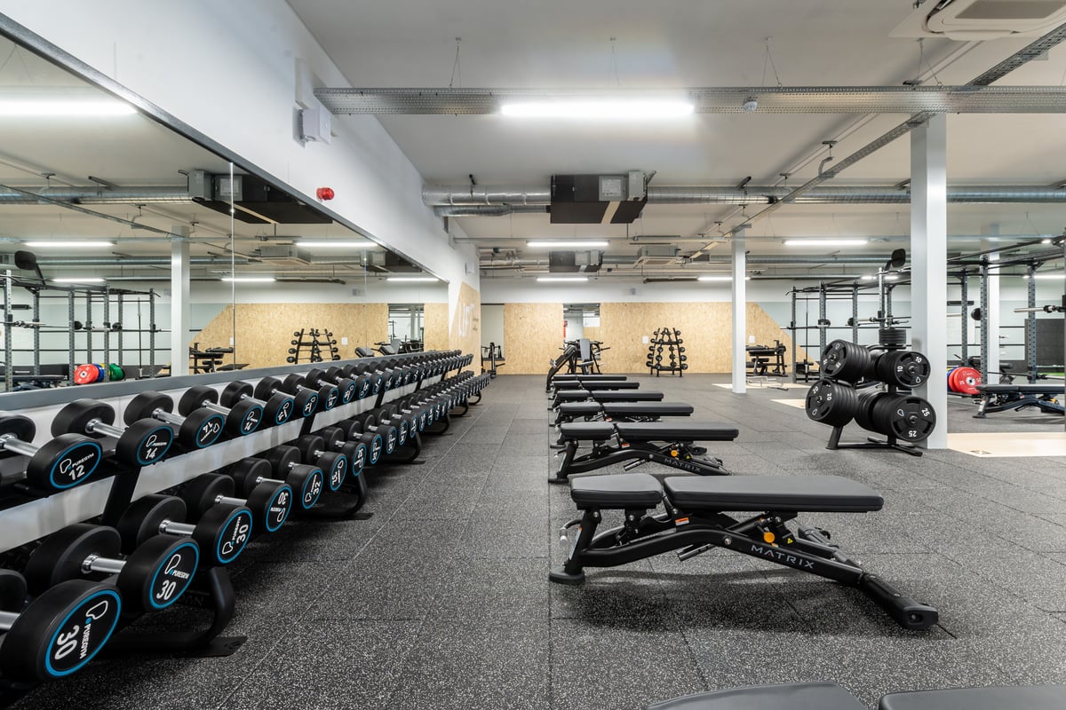 PureGym Peterborough Brotherhood Retail Park: Dumbbell racks, weight benches, mirrored walls, and rubberized flooring.