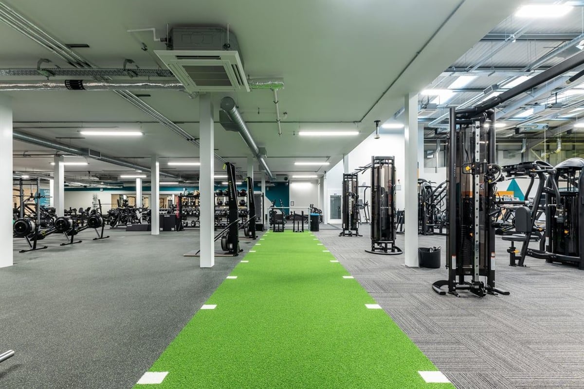 PureGym Broadstairs Westwood Gateway Retail Park: Rows of weightlifting machines, green turf track, and exercise equipment.