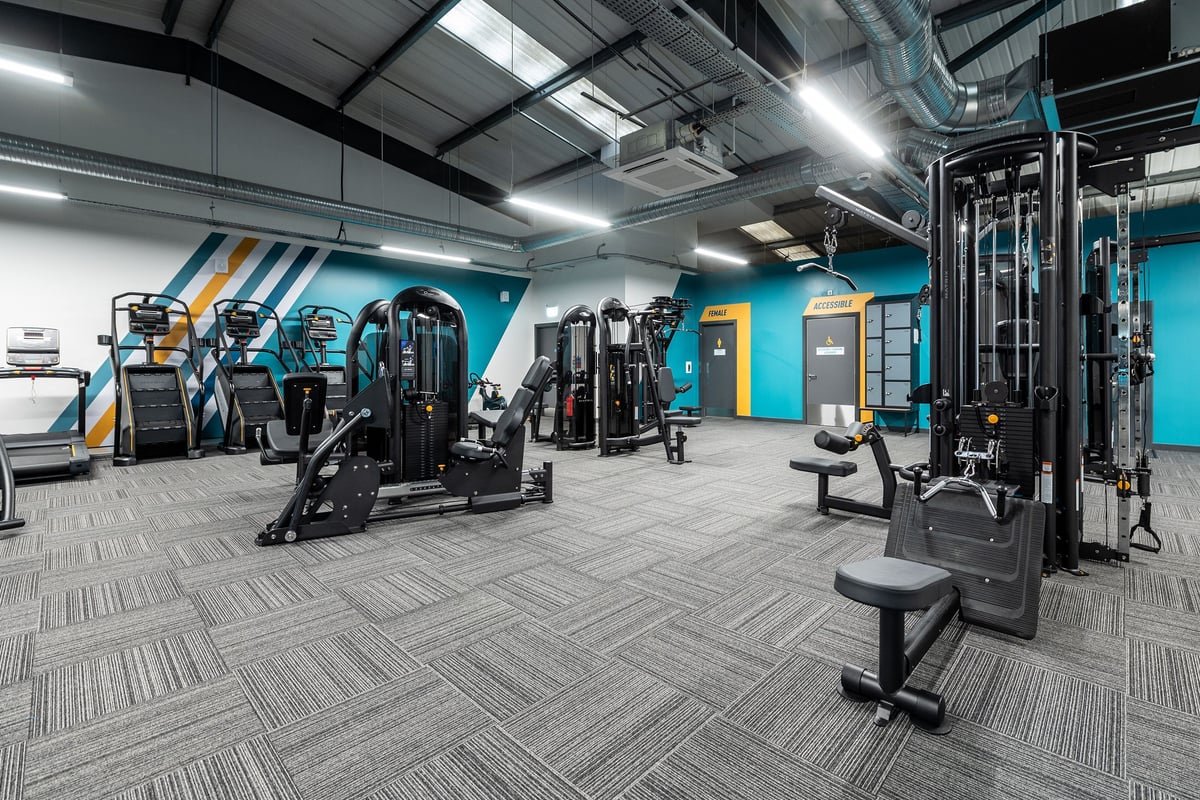 PureGym Letchworth: Weight machines, resistance equipment, free weights, benches, and rubberised flooring in a gym setting.
