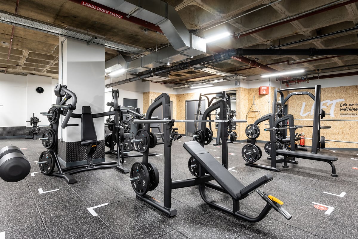 PureGym Maidstone The Mall: Weightlifting machines, benches, free weights, and rubberized floors in a basement gym setting.