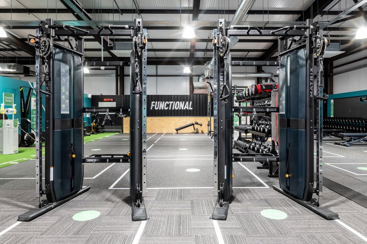 PureGym Kirkcaldy: Functional training area with hanging rigs, weightlifting platforms, free weights, and rubberized floors.
