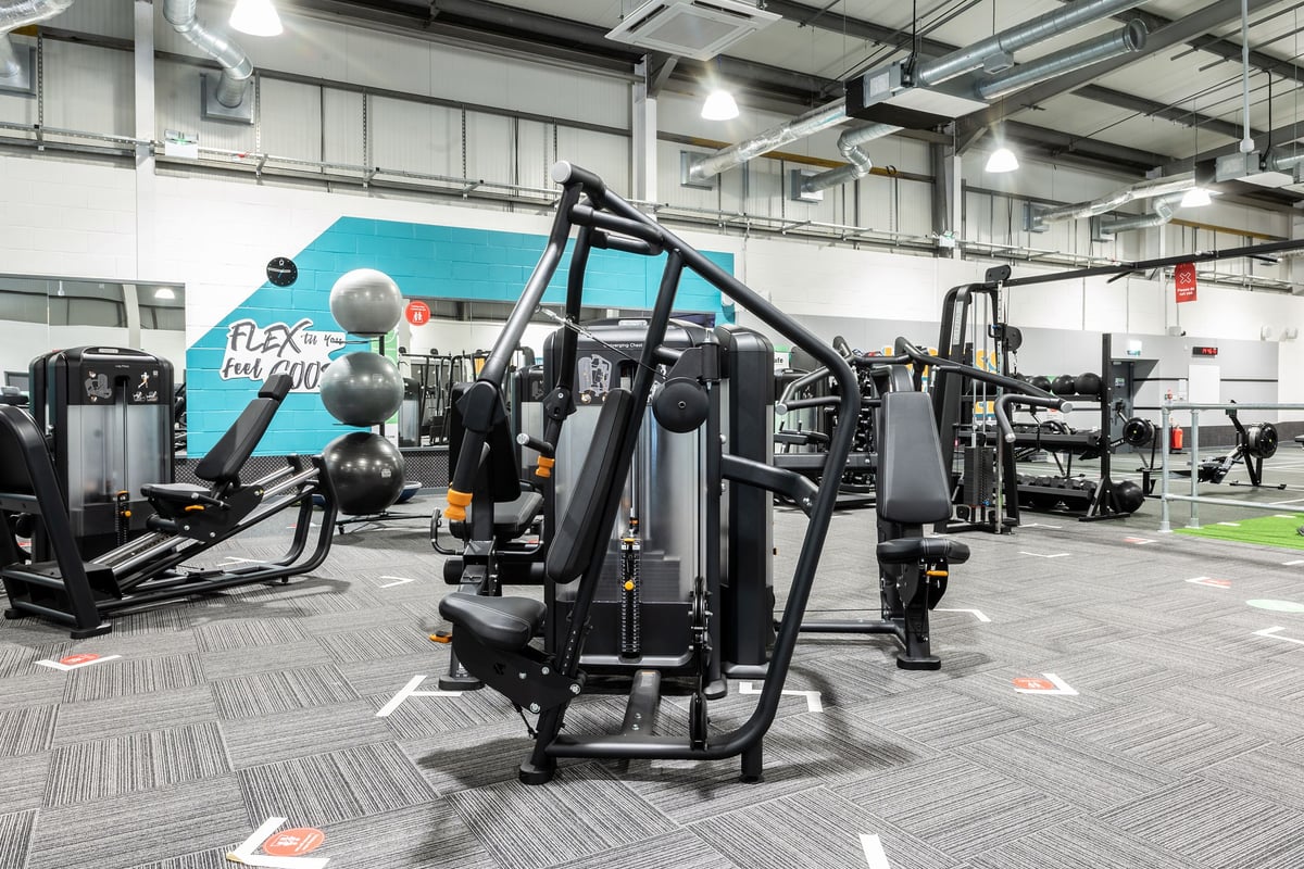 PureGym Swindon Stratton: Rows of resistance machines, weight stacks, adjustable cable pulleys, and rubberized floor tiles.