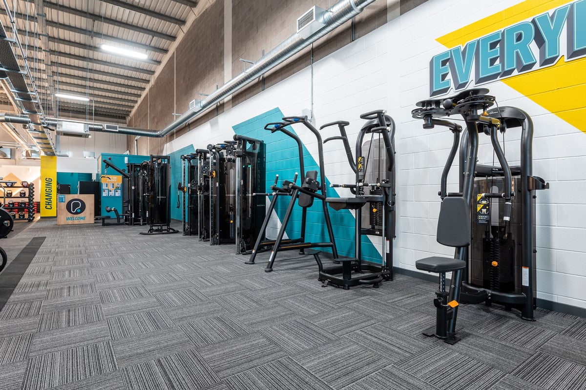 PureGym Shepton Mallet: Rows of resistance machines, weight stacks, and functional training equipment on rubberized flooring.