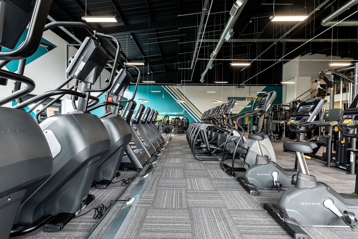 PureGym Doncaster: Rows of treadmills, ellipticals, and weight machines in a spacious gym facility.
