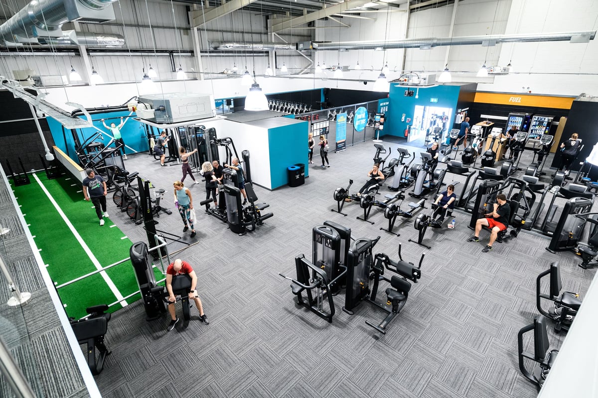 PureGym Folkestone: Large gym space with resistance machines, free weights, turf area, and workout equipment.