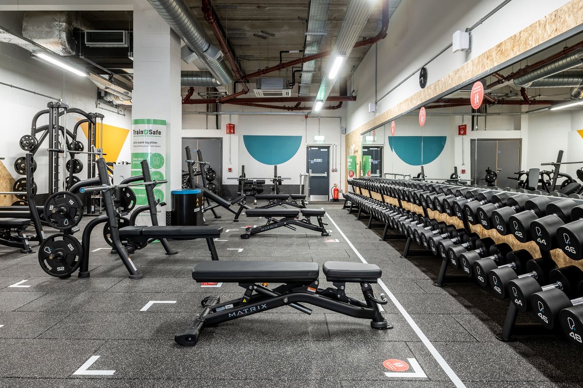 PureGym Chelmsford Meadows: Weights benches, resistance machines, barbells, weight plates, and rubberised flooring in a gym.