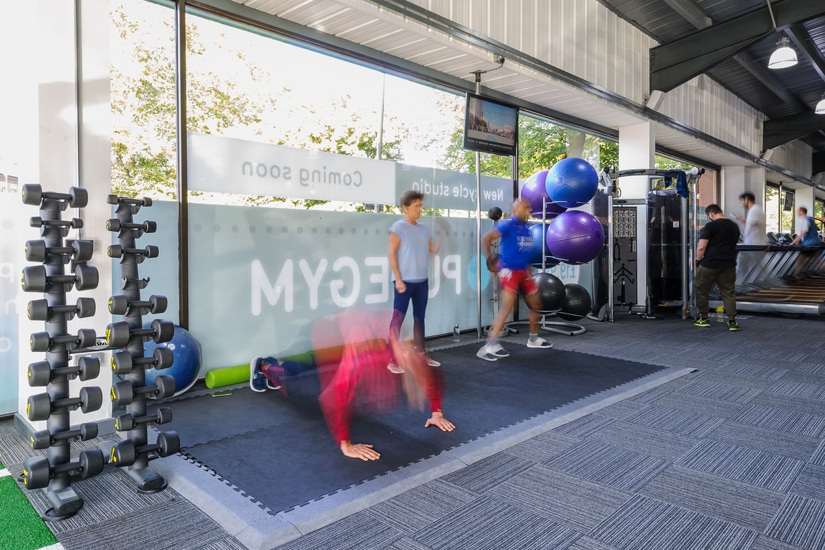 PureGym Leicester Walnut Street: Gym area with dumbbell racks, exercise balls, resistance bands, and rubberized flooring.