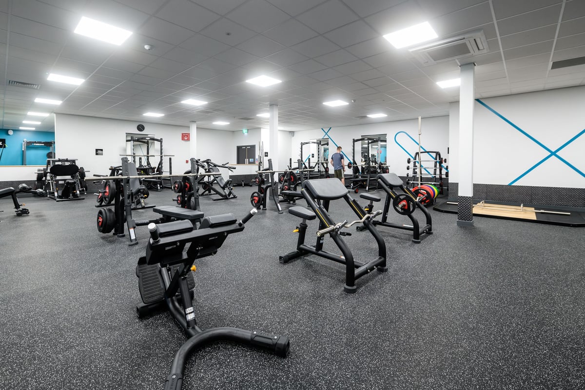 PureGym Southend Fossetts Park: Weight machines, benches, free weights, and rubberized flooring in a well-equipped gym.