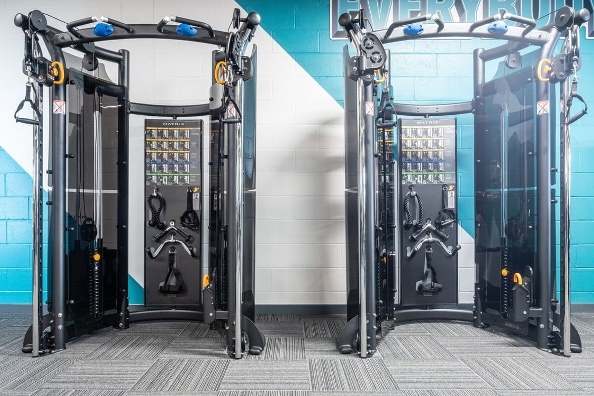 PureGym Lanark: Functional training stations with cable pulleys, weight stacks, and open frames.