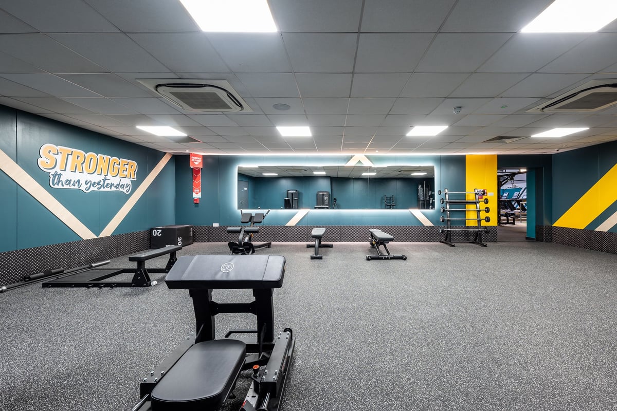 PureGym London Marylebone: Weight benches, mirrored walls, rubberized flooring, motivational graphics in a gym setting.