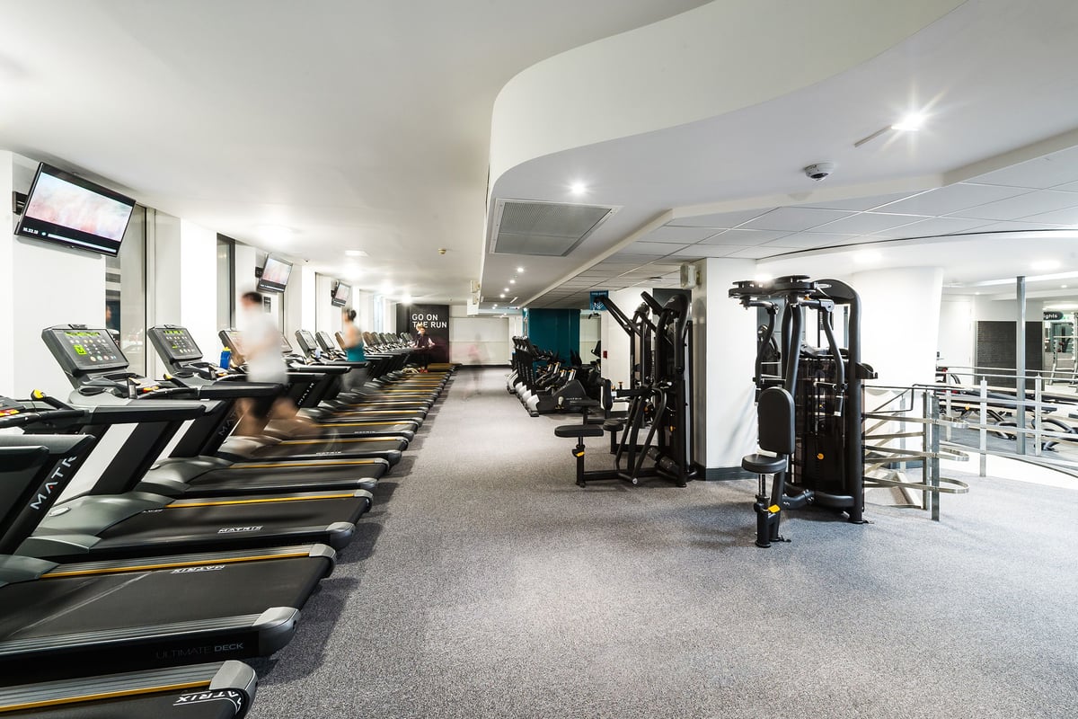 PureGym London Holborn: Rows of treadmills, weight machines, and strength equipment in a modern, well-lit fitness center.