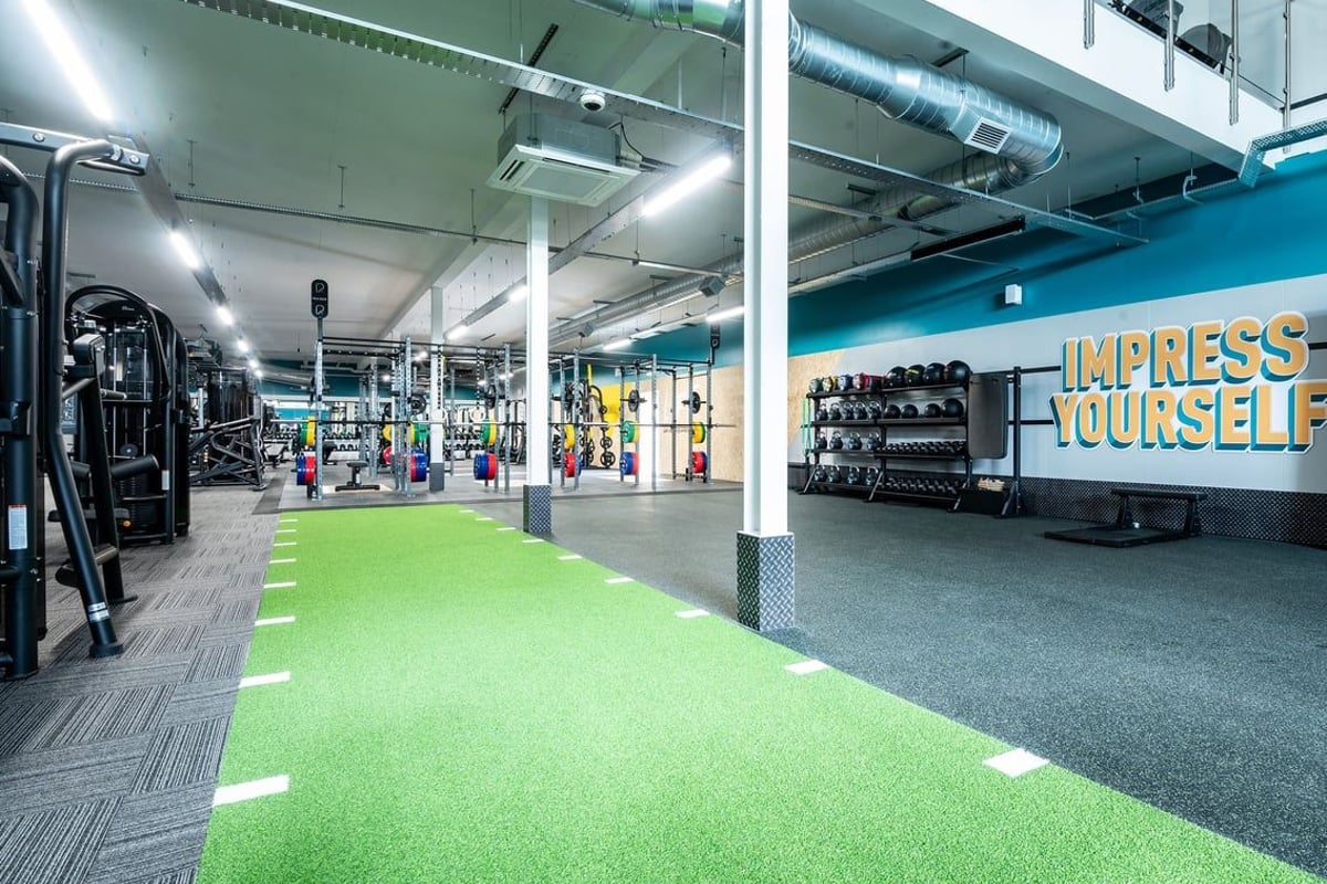 PureGym Glasgow Rutherglen: Weight racks, cardio machines, turf area and free weights.